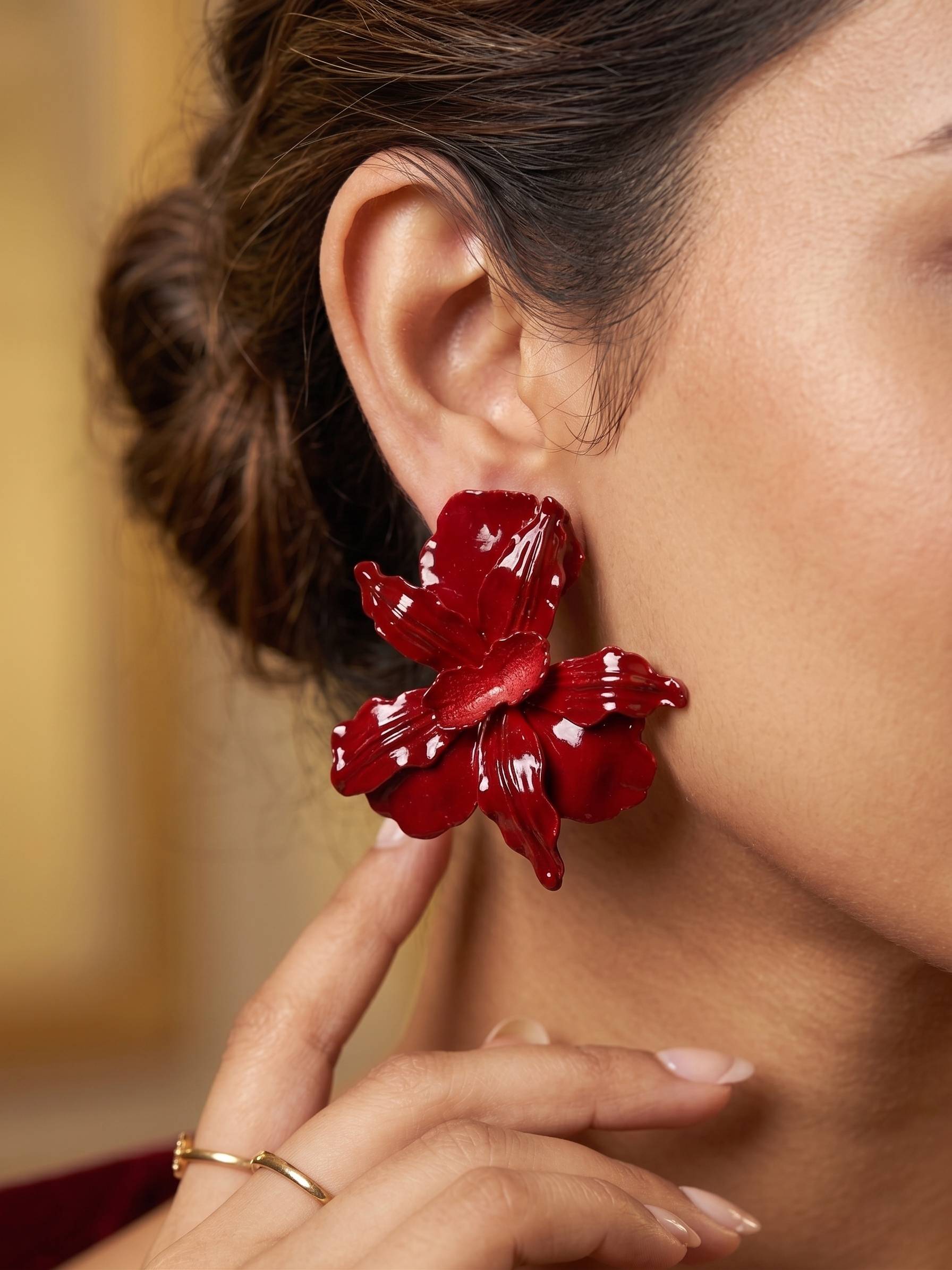 Blends trendy earrings traditional floral motifs with modern, oversized aesthetics.