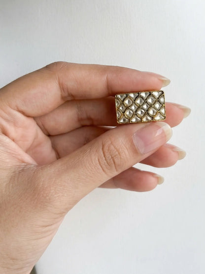 Elegant female engagement rings with a unique rectangular Polki stone setting in golden