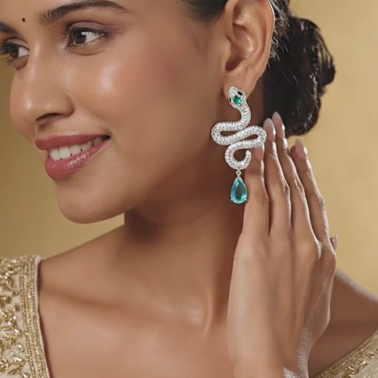 Handcrafted silver serpent earrings with teardrop gemstone detail