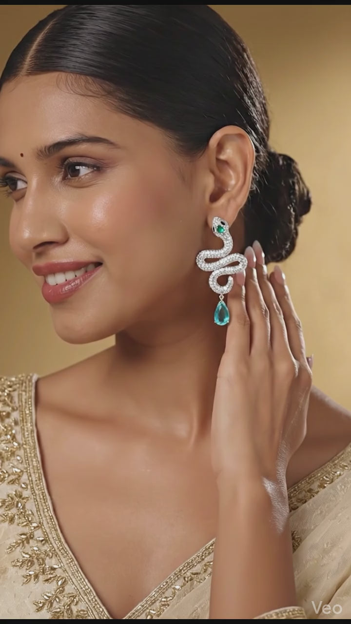 Handcrafted silver serpent earrings with teardrop gemstone detail