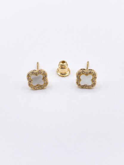 Gold square earrings with a central gemstone on a white background