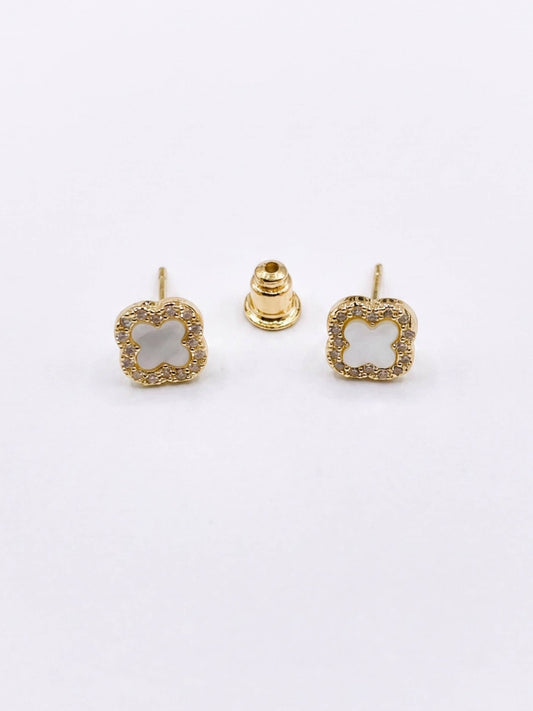 Gold square earrings with a central gemstone on a white background