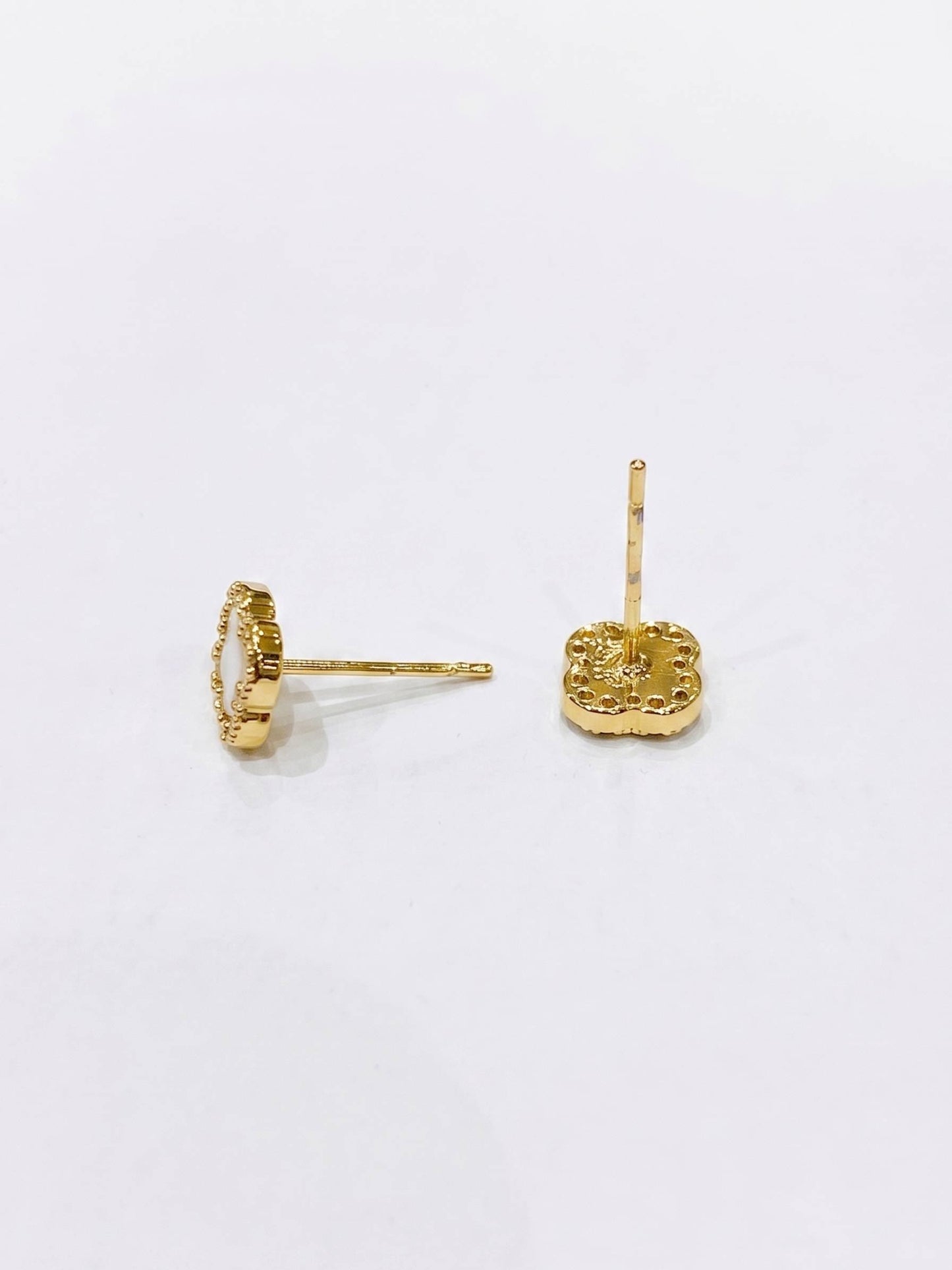 Gold earrings on a white background