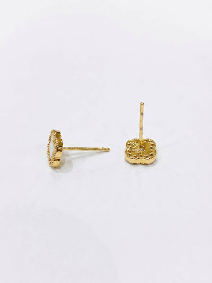Gold earrings on a white background