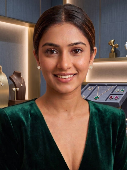 Woman wearing earrings with jewelry display in the background