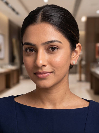 Woman wearing earrings in a blurred interior setting