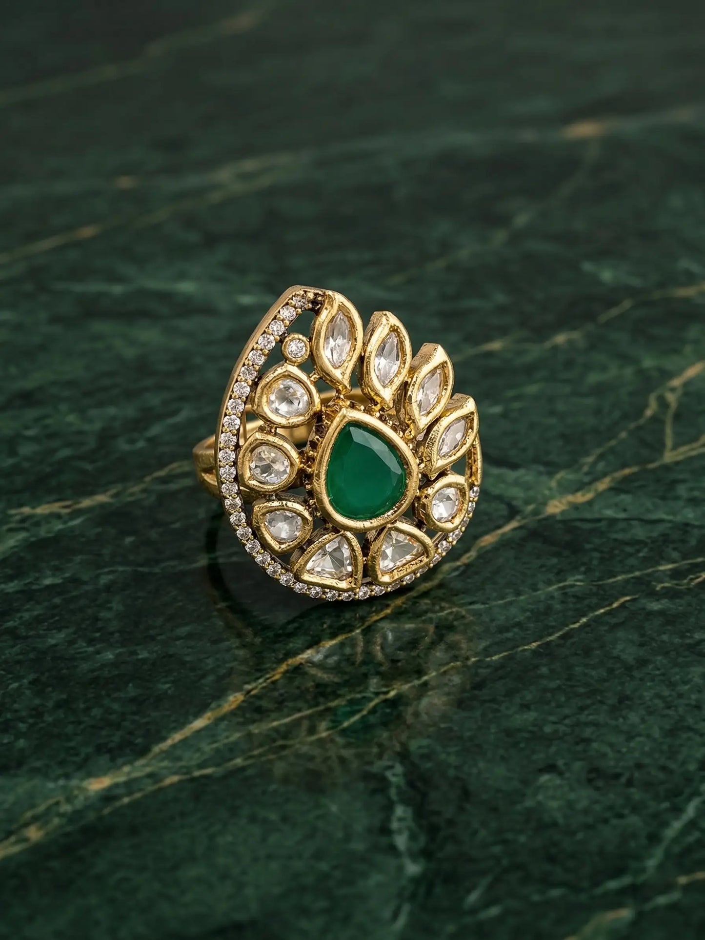 Traditional Indian bridal jewelry ring for women featuring polki and green stone accents