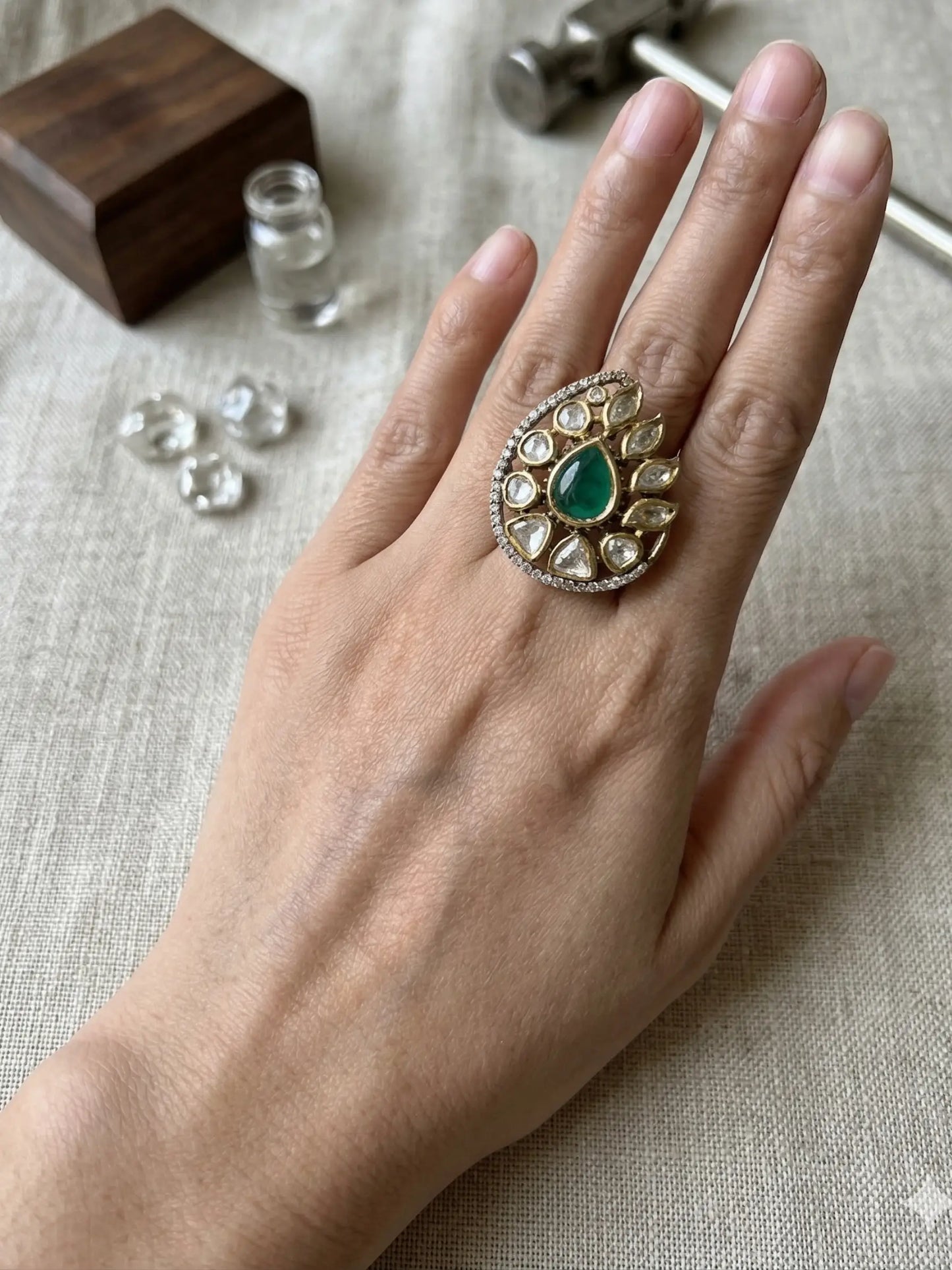 Elegant ladies ring with green gemstone and gold-tone kundan border