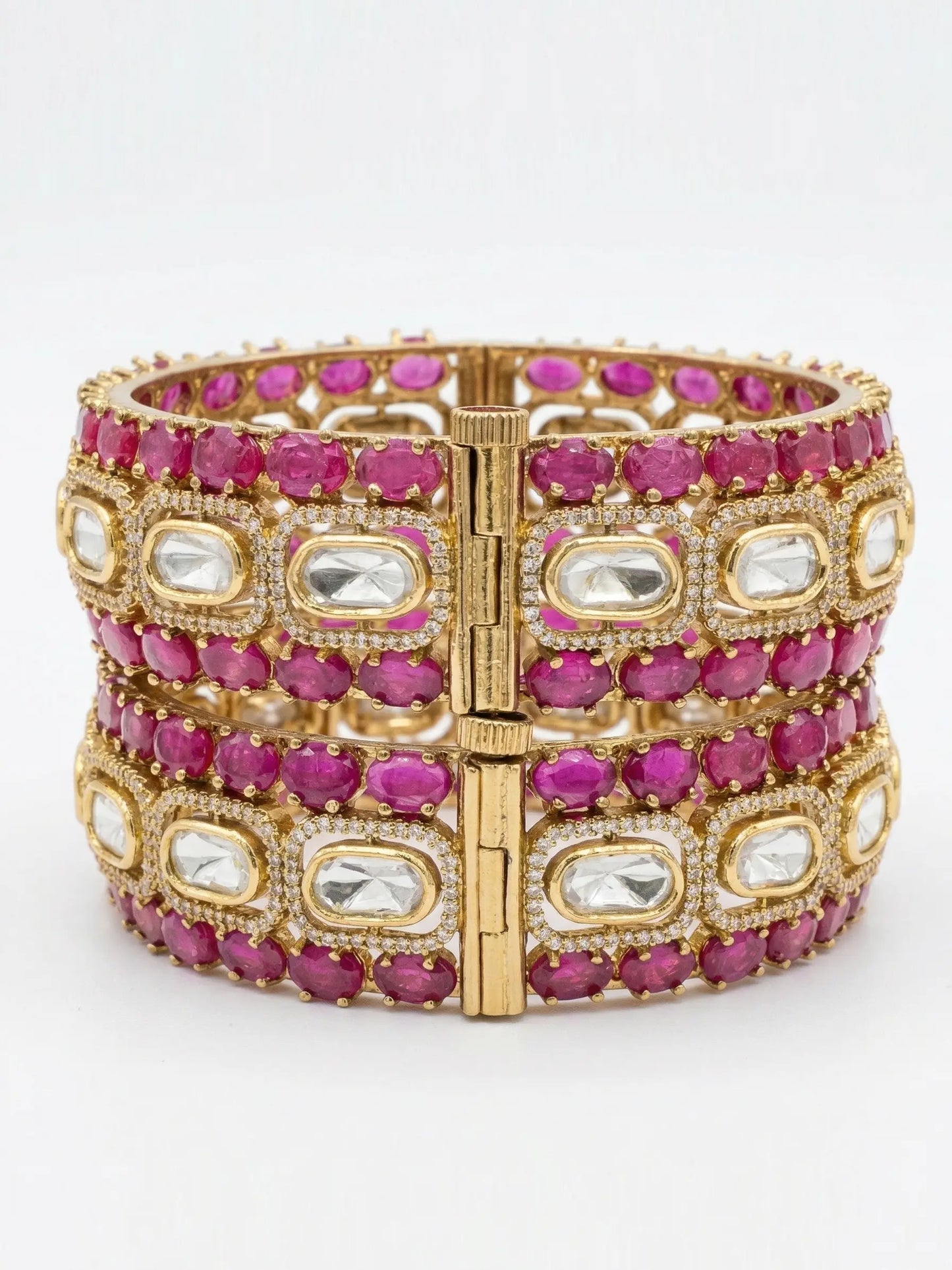 ruby bracelet with pink and clear gemstones on a white background