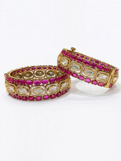 Two victorian ruby bangles on a white background