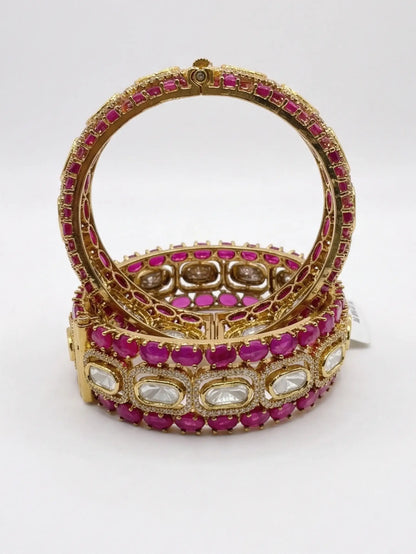 screw bangles with pink and white stones on a white background