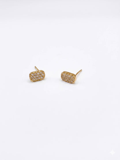 Gold stud earrings on a white background